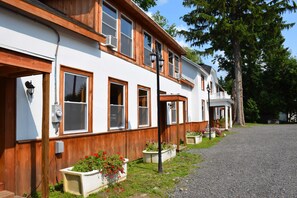 A two-story building with a white exterior and wooden trim. - Townhouse Hotel (Richfield Springs)
