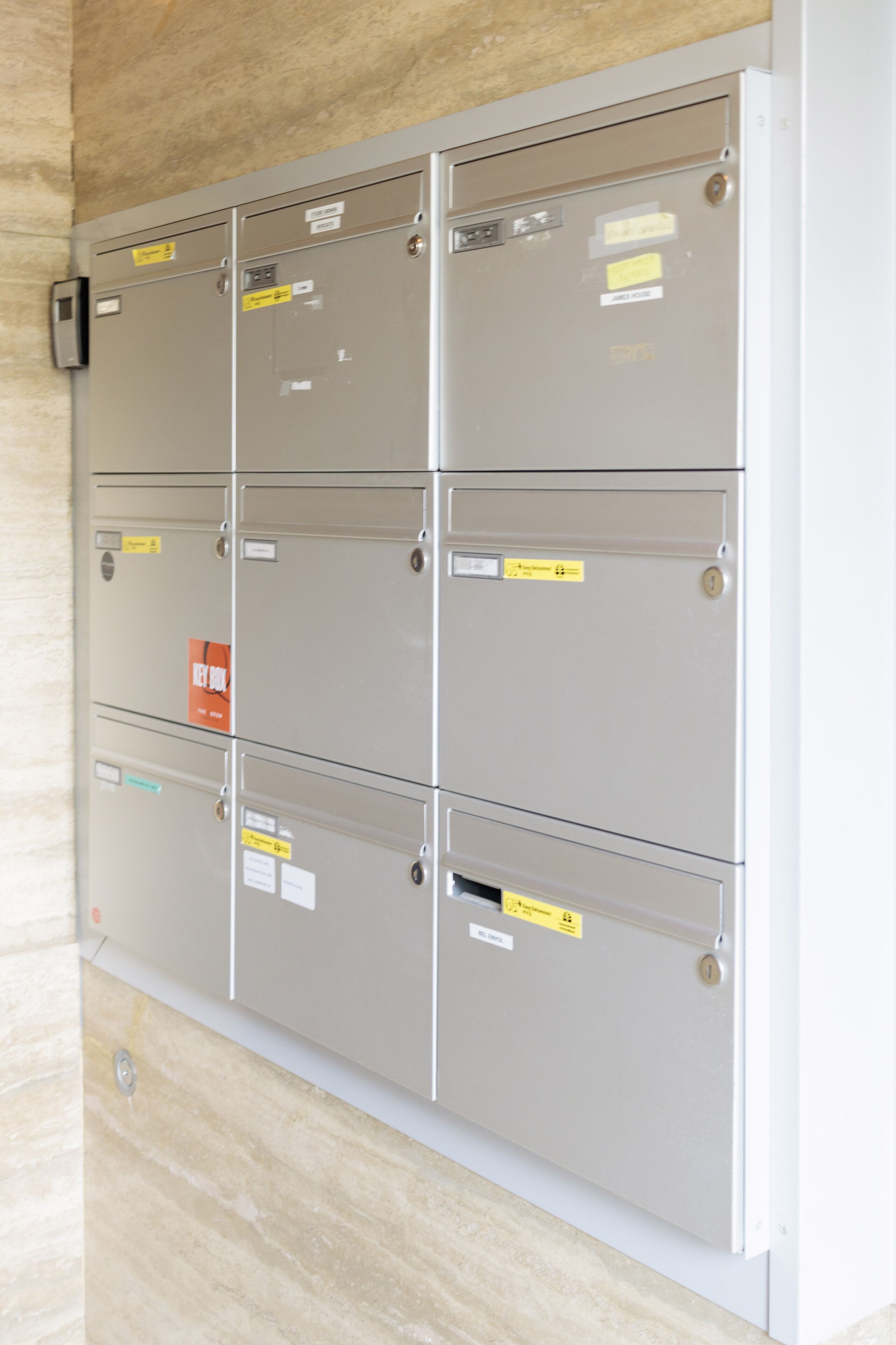 A row of metal storage lockers with labels and a security lock.