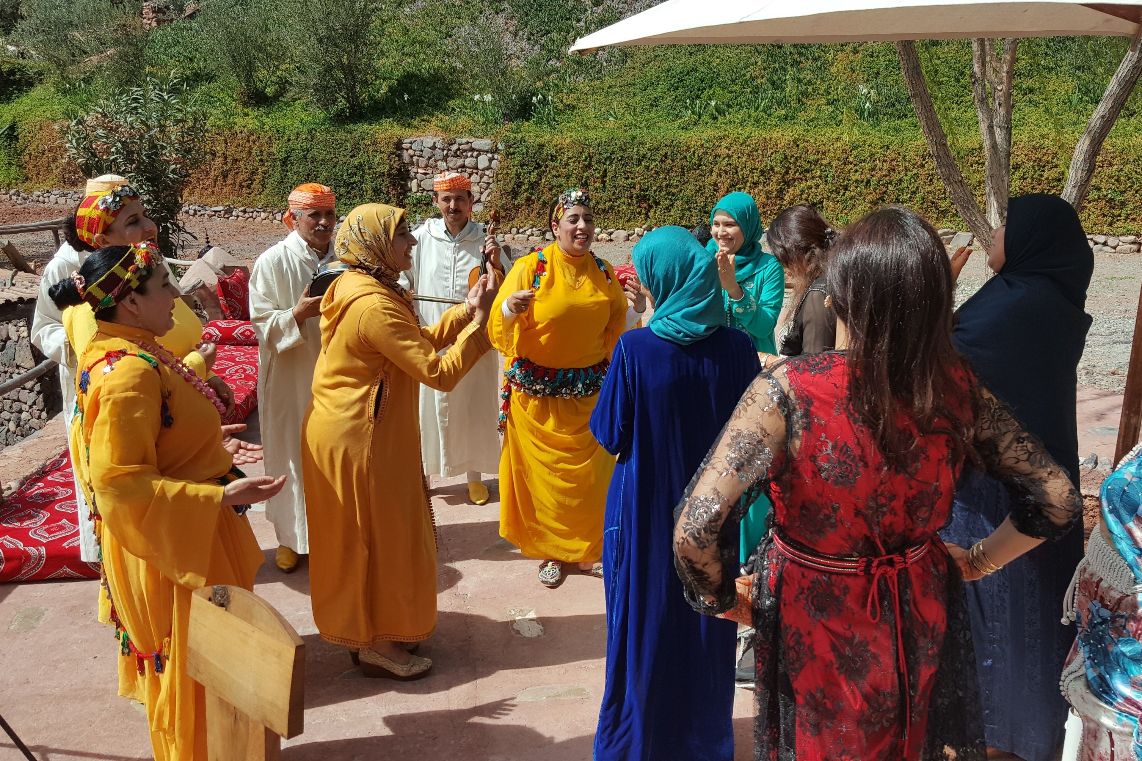 A group of people in traditional attire gathered outdoors, possibly for a cultural event or ceremony.