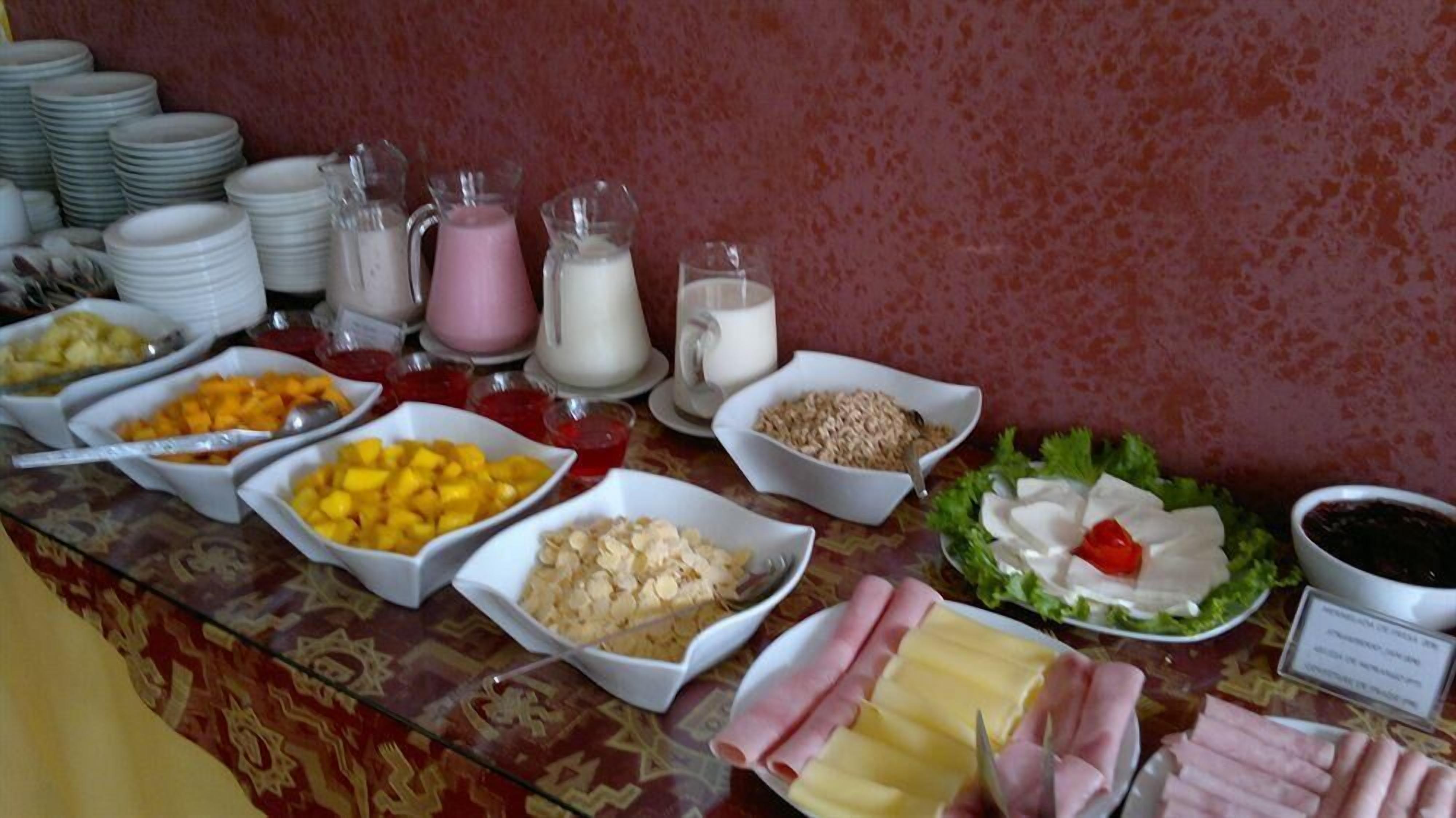 A buffet with various food items and beverages.