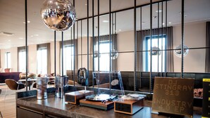 A modern bar area with DJ Stingray's nameplate, a disco ball, and a mix of bar equipment. - Motel One Berlin-Potsdamer Platz (Berlin)