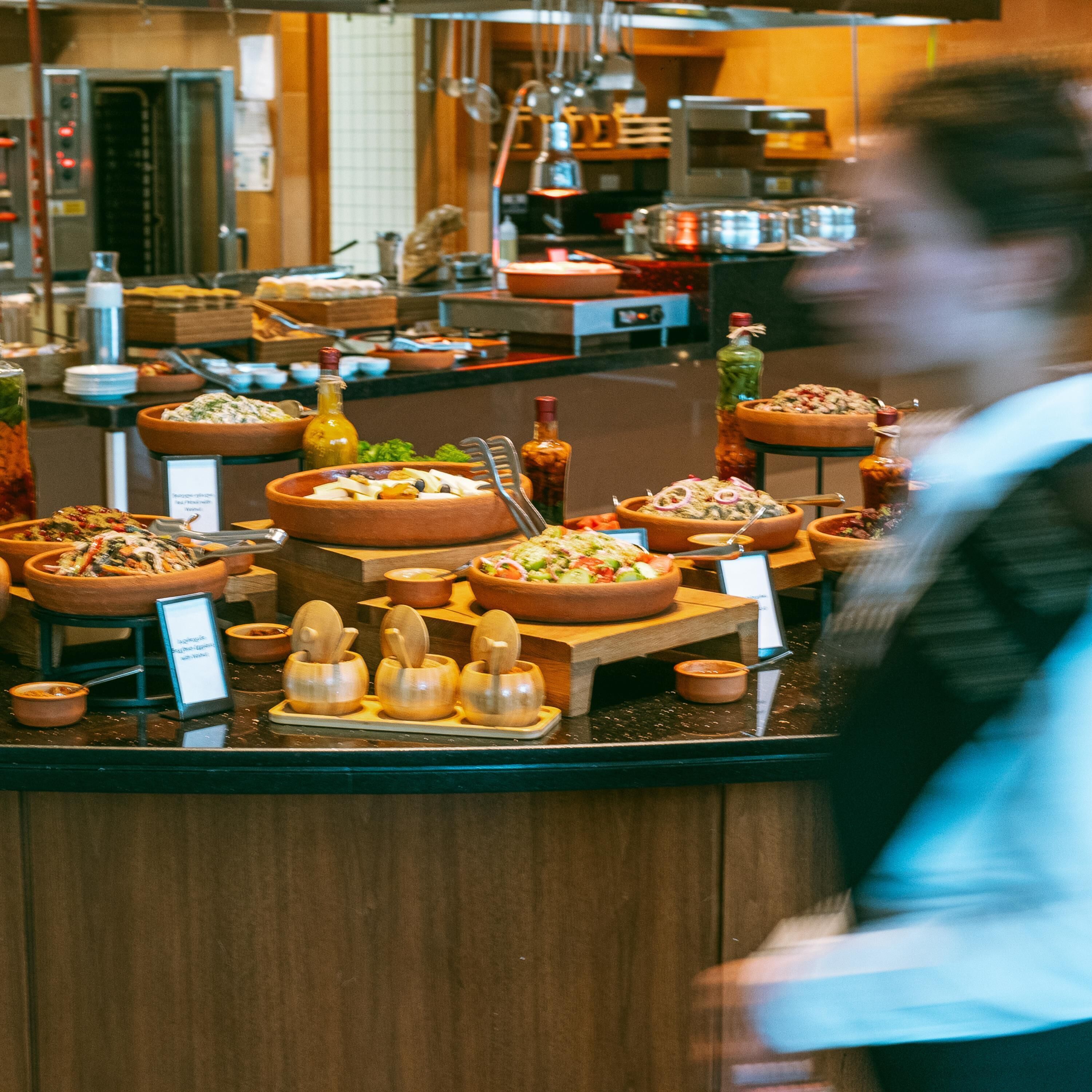 A buffet with various dishes and condiments.