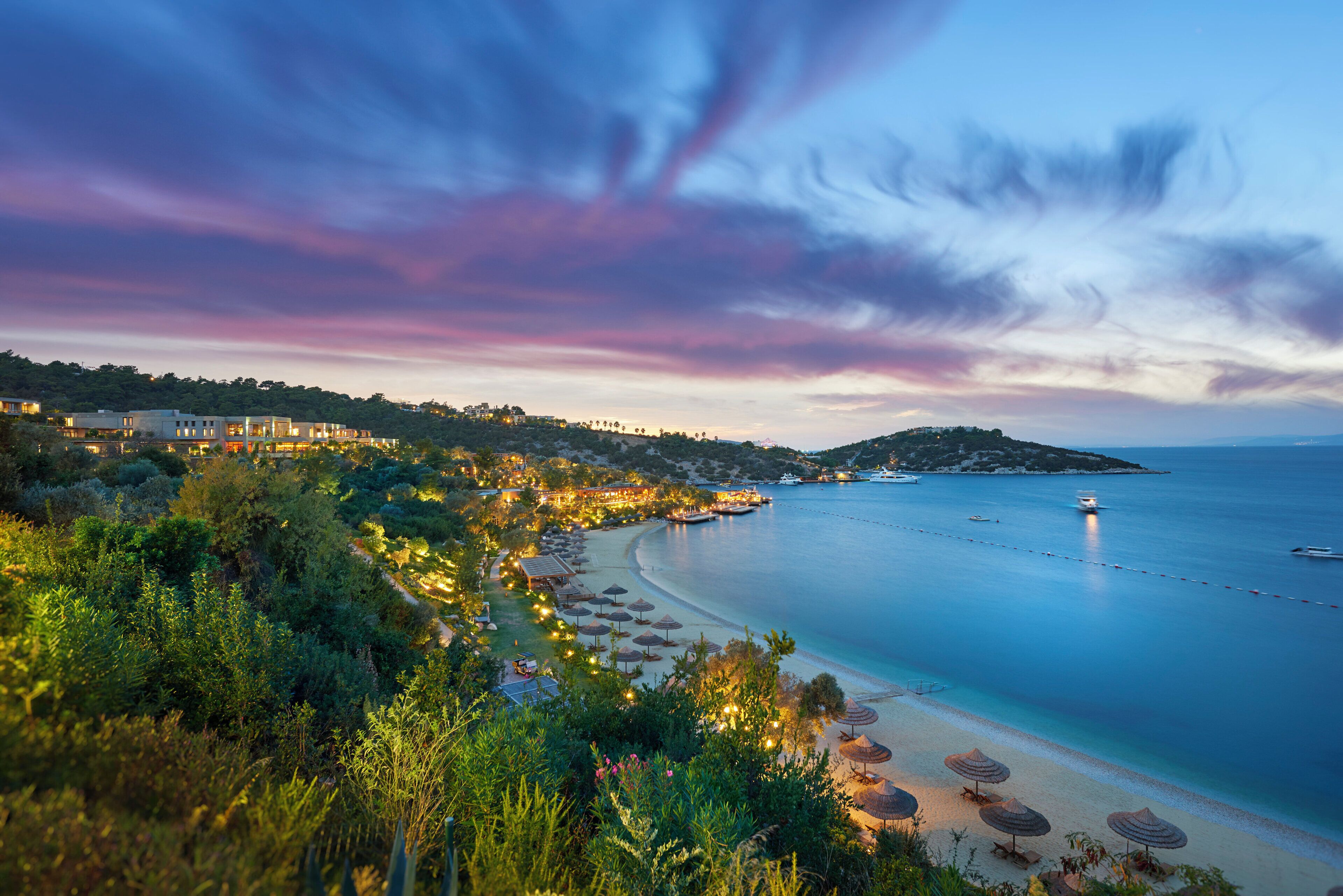 A coastal resort with a beachfront, overwater bungalows, and a view of the sea.