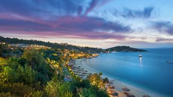 A coastal resort with a beachfront, overwater bungalows, and a view of the sea.