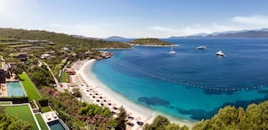 A coastal resort with a beach, clear blue waters, and boats. - Mandarin Oriental, Bodrum (Bodrum)