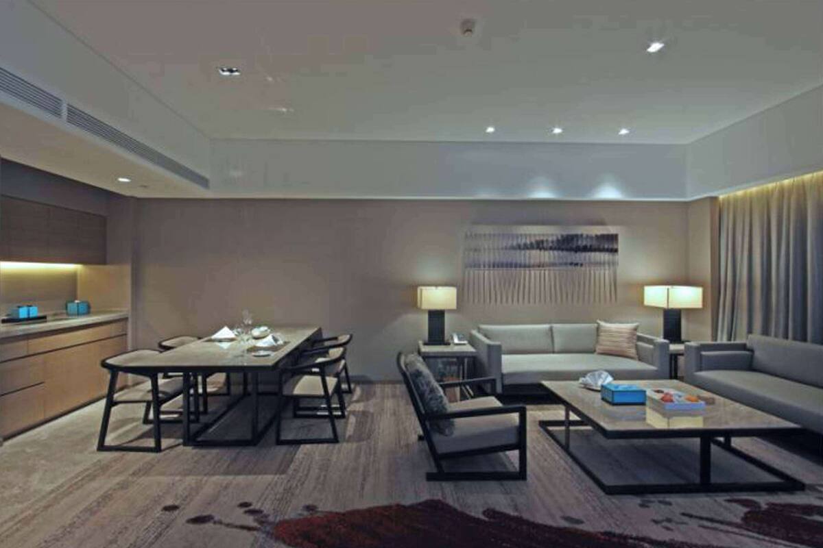 A modern living room with a dining area, a sofa set, and a coffee table.