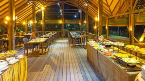 An indoor dining area with wooden beams, tables, and a buffet. - Siddhalepa Ayurveda Resort - All Meals, Ayurveda Treatment, Yoga (Wadduwa)