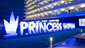 A multi-story hotel with a large illuminated sign reading "PRINCESS HOTELS". - Hotel Gran Canaria Princess - Adults Only (+16) (San Bartolomé de Tirajana)