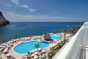 A resort with a large pool area, a beach, and a view of the ocean. - Hotel Princess Taurito - All Inclusive (Mogan)