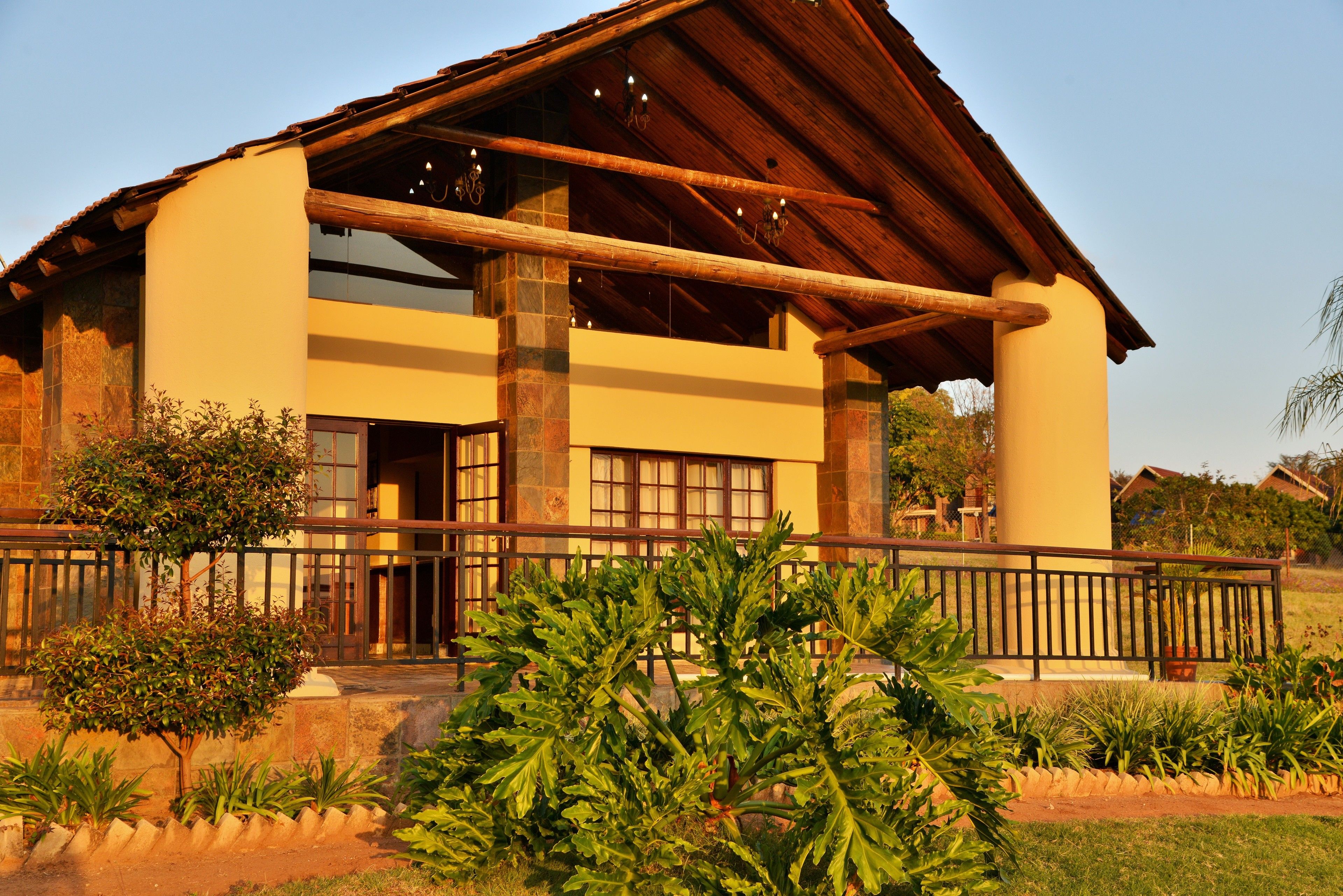 A two-story building with a wooden roof and large windows.