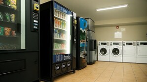 A laundromat with vending machines and washing machines.