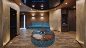 A modern lobby with a circular water feature, a seating area, and a reception desk. - Olymp 3 (Kolobrzeg)