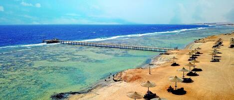 Private beach, beach umbrellas, beach towels, scuba diving