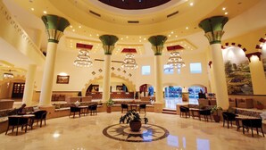 A spacious lobby with high ceilings, large columns, and a central fountain. - Bliss Nada Beach Resort (Marsa Alam)