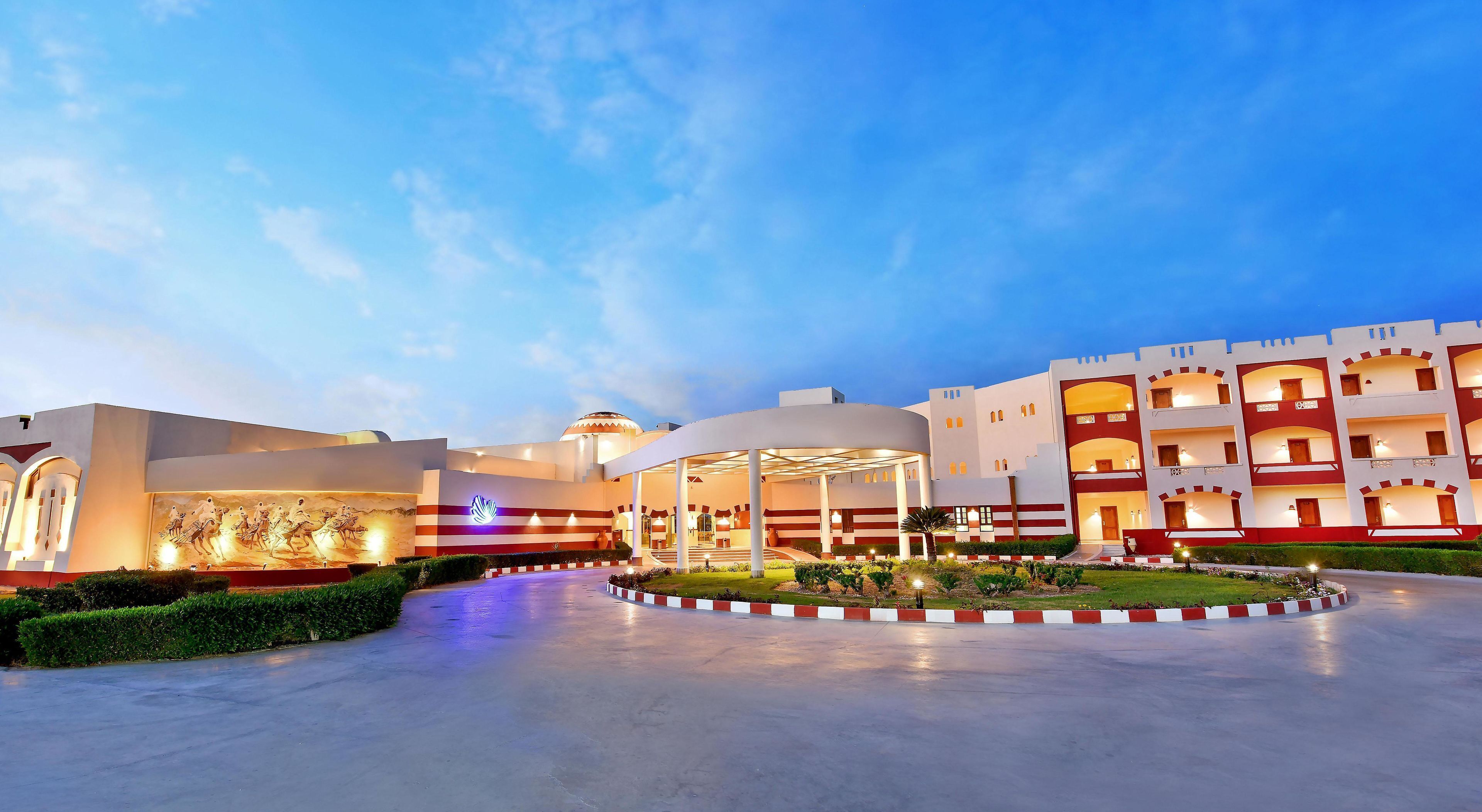 A hotel with a central courtyard, multiple floors, and a distinctive architectural style.