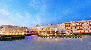 A hotel with a central courtyard, multiple floors, and a distinctive architectural style. - Bliss Nada Beach Resort (Marsa Alam)