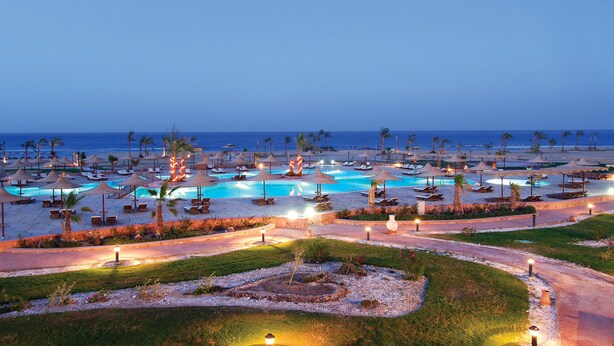 A resort with multiple swimming pools, lounge chairs, and umbrellas. - Bliss Nada Beach Resort (Marsa Alam)