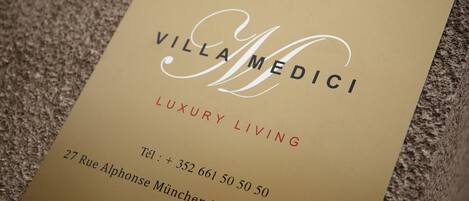A business card for Villa Medici Luxury Living.