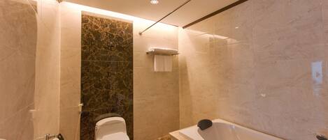 A modern bathroom with a toilet, shower, and bathtub.