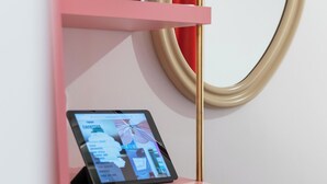 A pink shelf with a tablet displaying a menu. - Trendy Canette Hotel (Paris)