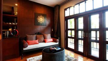 A living room with a sofa, coffee table, and a large window with a view.