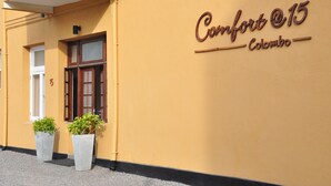 A building with a sign reading "Comfort @15 Colombo" and two potted plants at the entrance. - Comfort@15 Hotel Colombo (Colombo)