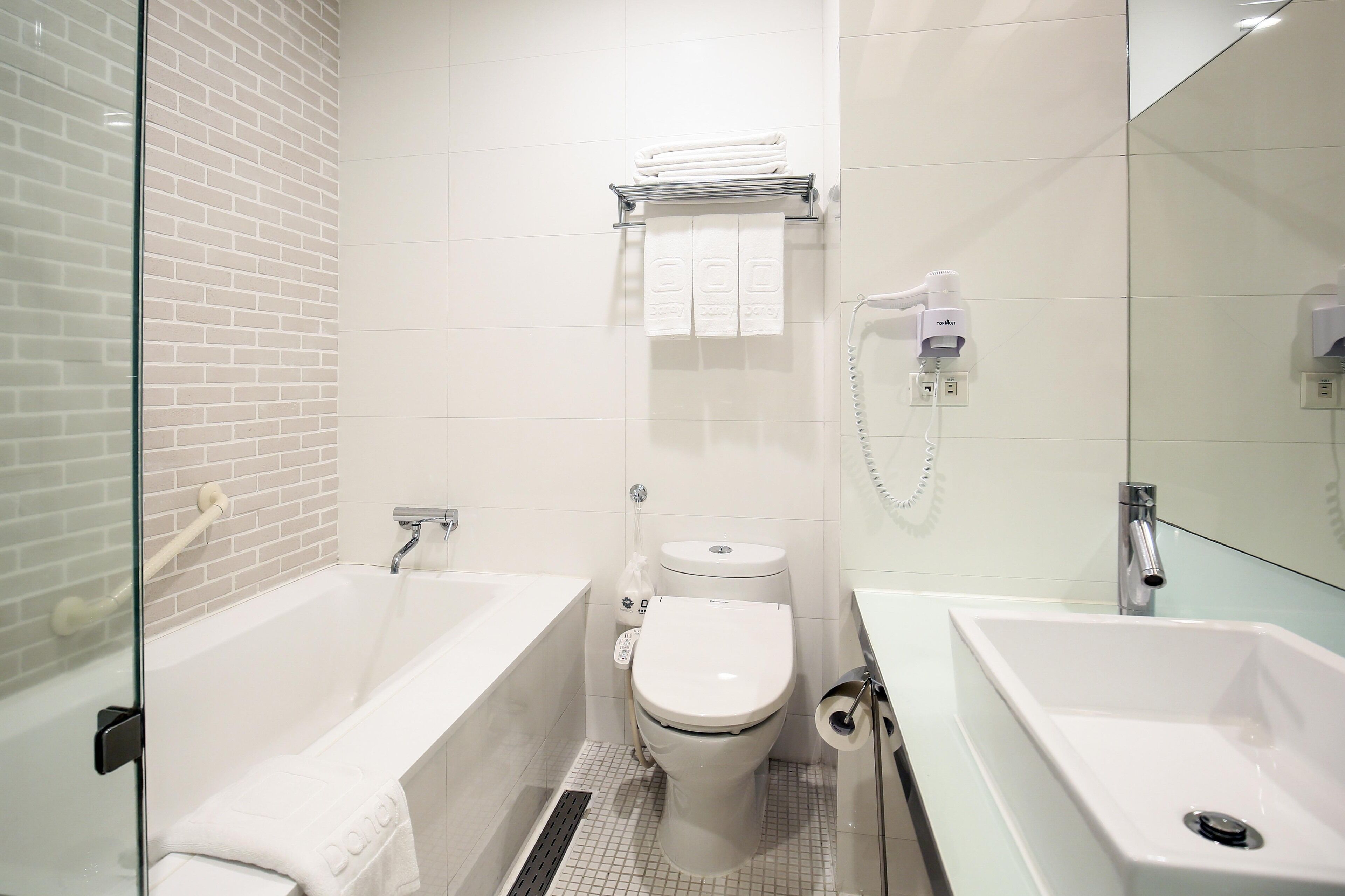 hair dryer, slippers, bidet, towels