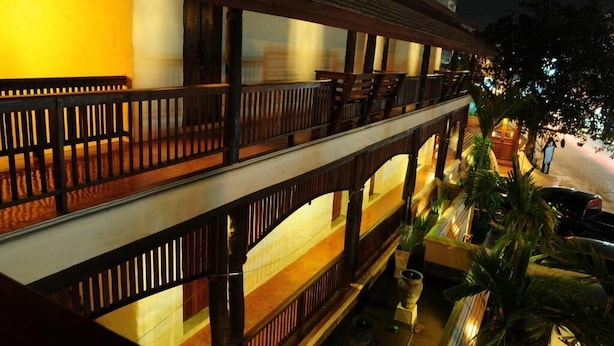 A multi-story building with balconies, wooden railings, and outdoor seating areas. - Villa Korbhun Khinbua (Chiang Mai)