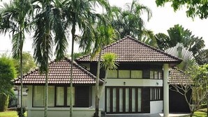 A two-story building with a tiled roof and a covered porch. - Pattaya Country Club (Bang Lamung)
