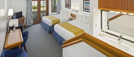 A hotel room with two beds, a desk with a computer, a chair, a large window with curtains, and a wooden ceiling.