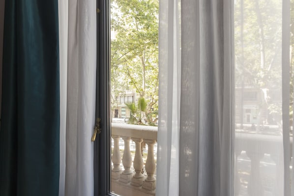 A view through a window with a balustrade, curtains, and a door. - Umma Barcelona Bed & Breakfast Boutique (Barcelona)