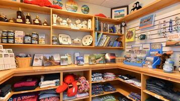 A store with shelves of books, travel guides, and souvenirs.