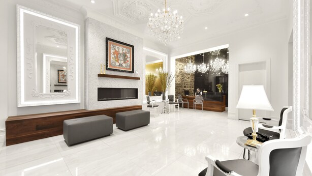 A spacious, well-lit living room with a large chandelier, a fireplace, and modern furniture. - Hotel Bonaparte  (Montreal)