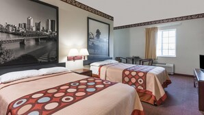 A hotel room with two beds, a large cityscape painting, a desk, and a window with curtains.