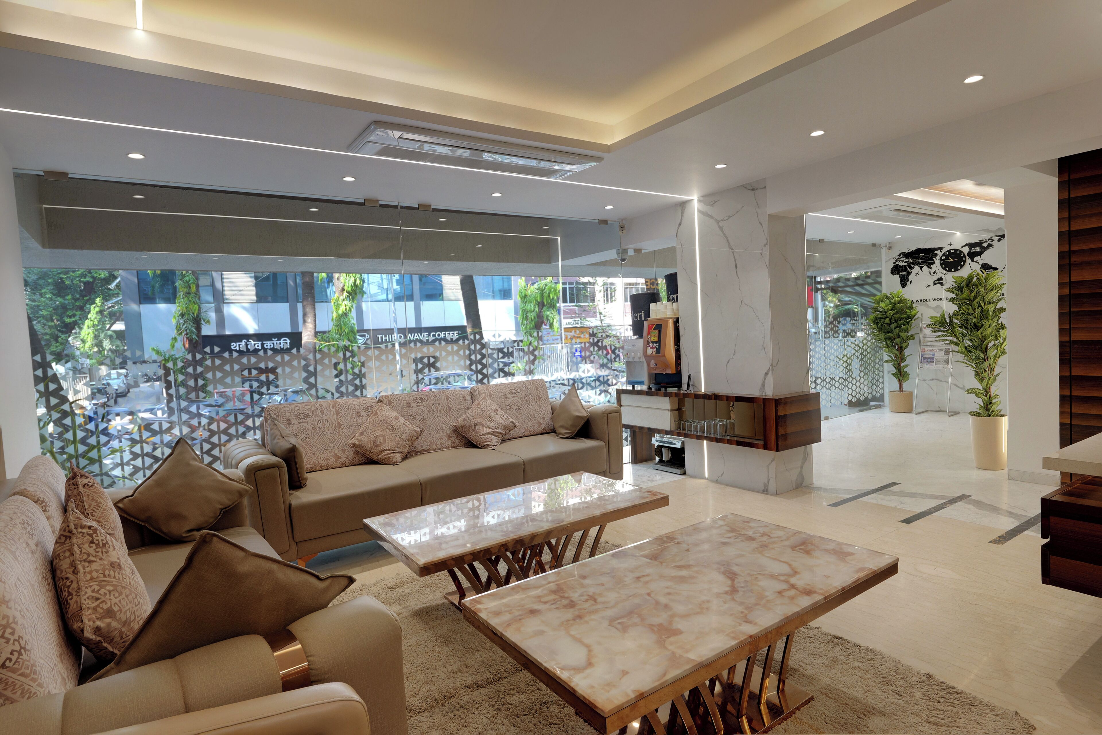 A modern living area with a sofa, two coffee tables, and a fireplace.