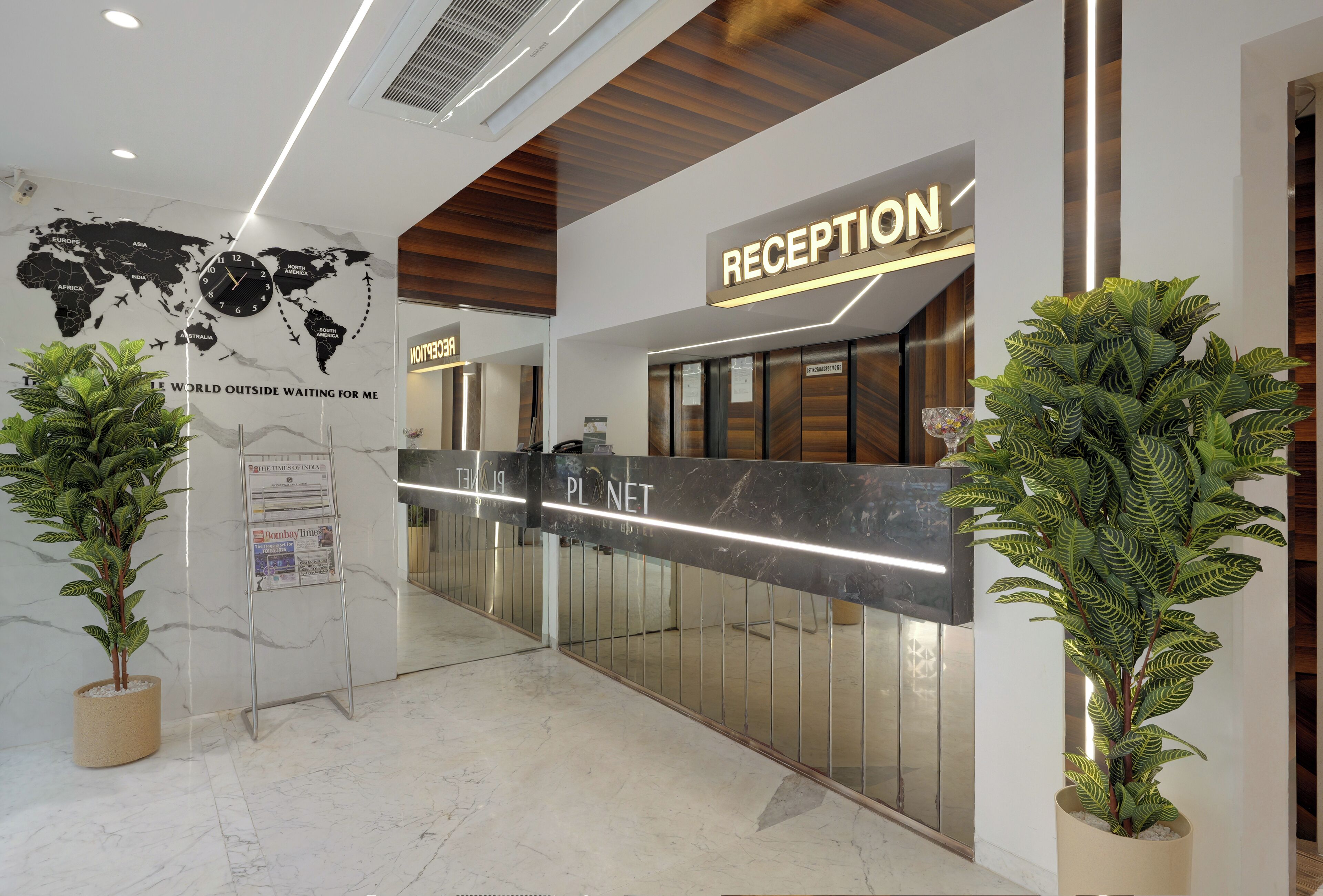 A reception area with a world map, a sign for 'Planet', and a reception desk.