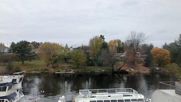 A river with a dock and a boat named 'Lady Muskie'.