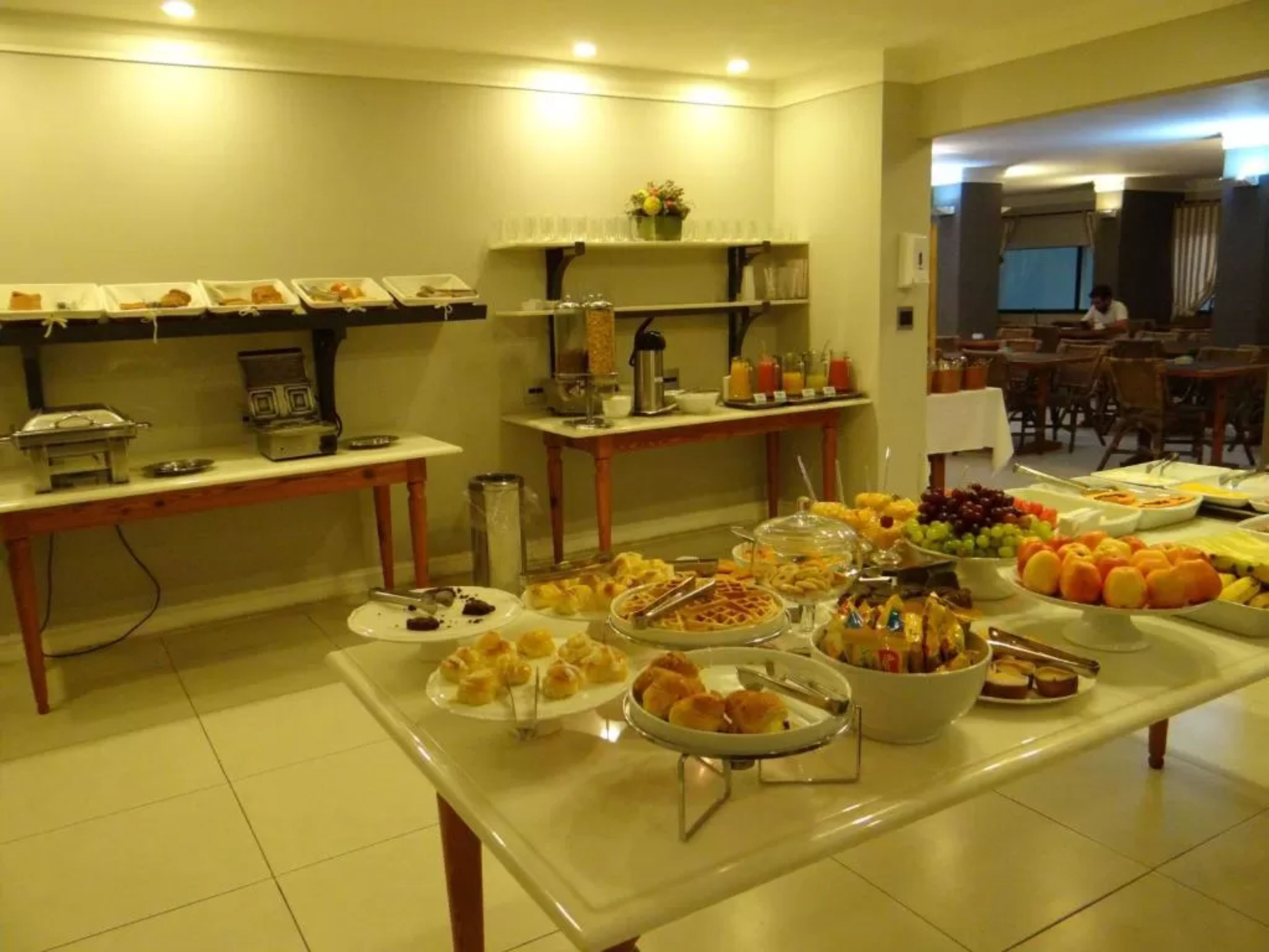A buffet setup with various food items and a coffee station.