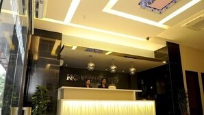 Un comptoir d’accueil d’hôtel au design moderne, doté d’une grande fenêtre et d’un plafond agrémenté d’une lucarne.