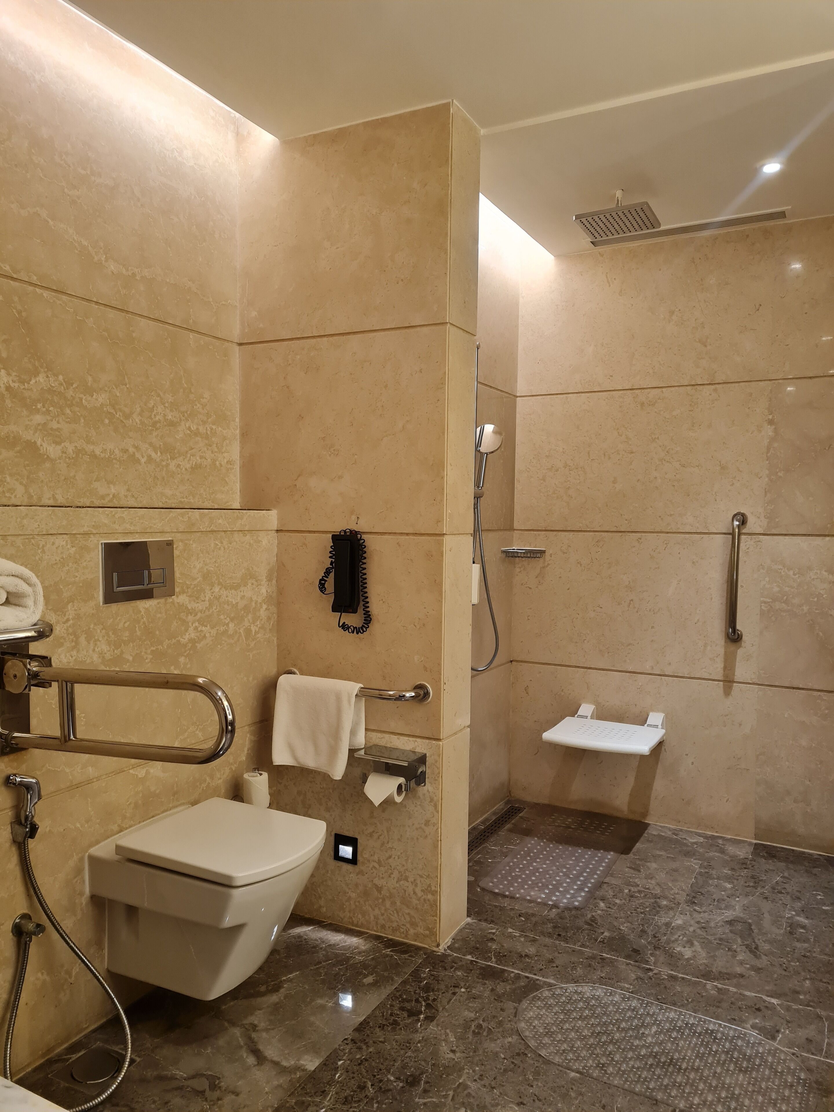 A modern bathroom with a toilet, bidet, and shower.