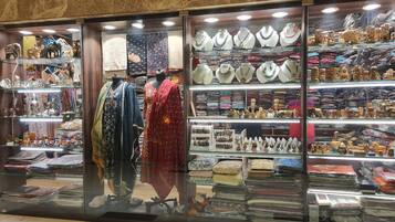 A jewelry store with glass display cases and mannequins.