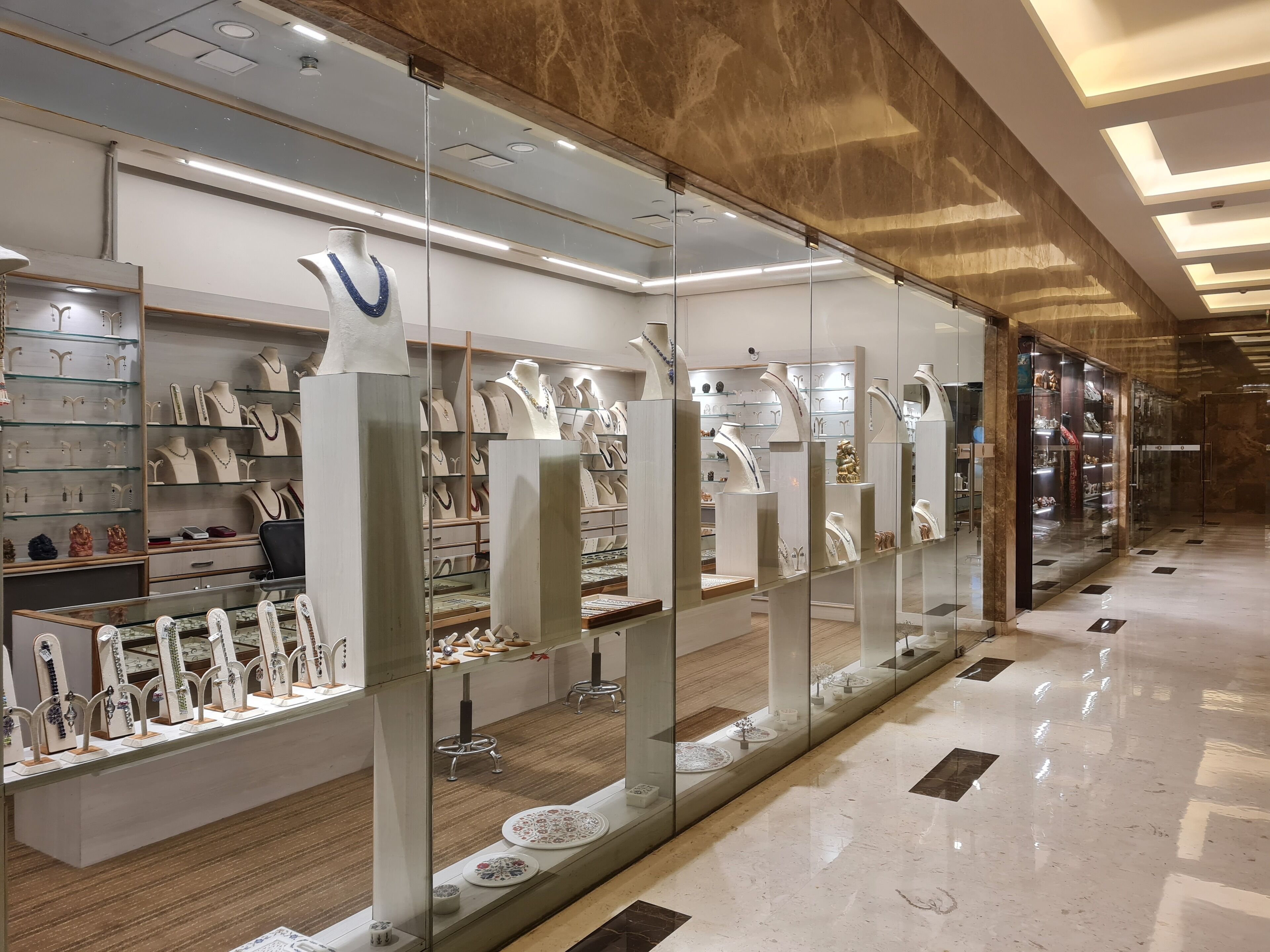 A jewelry store with glass display cases and a marble floor.