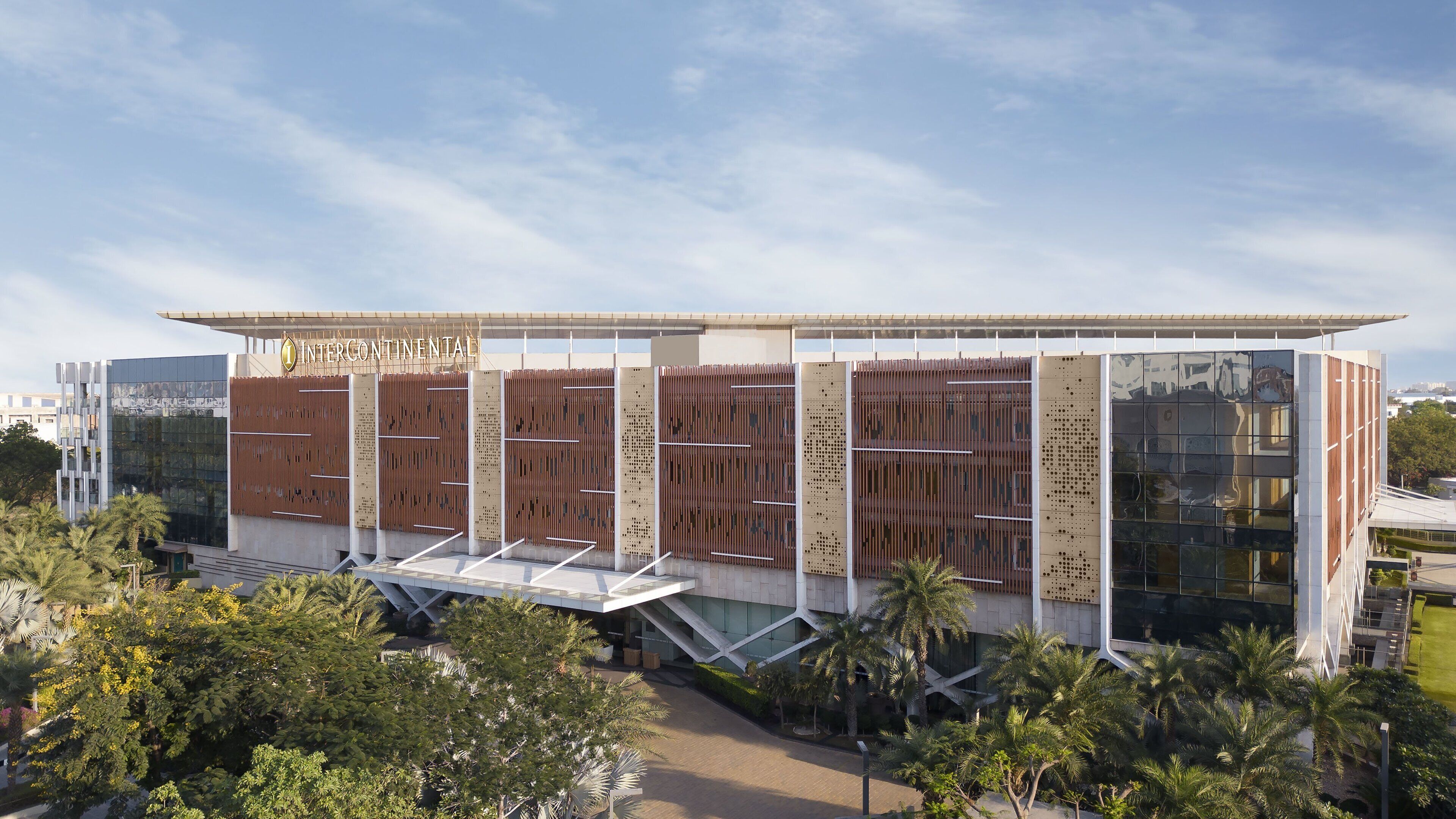 A modern building with a flat roof, large glass windows, and a sign reading "INTERCONTINENTAL".
