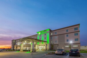 A Holiday Inn hotel with a modern design, featuring a covered entrance and multiple floors.