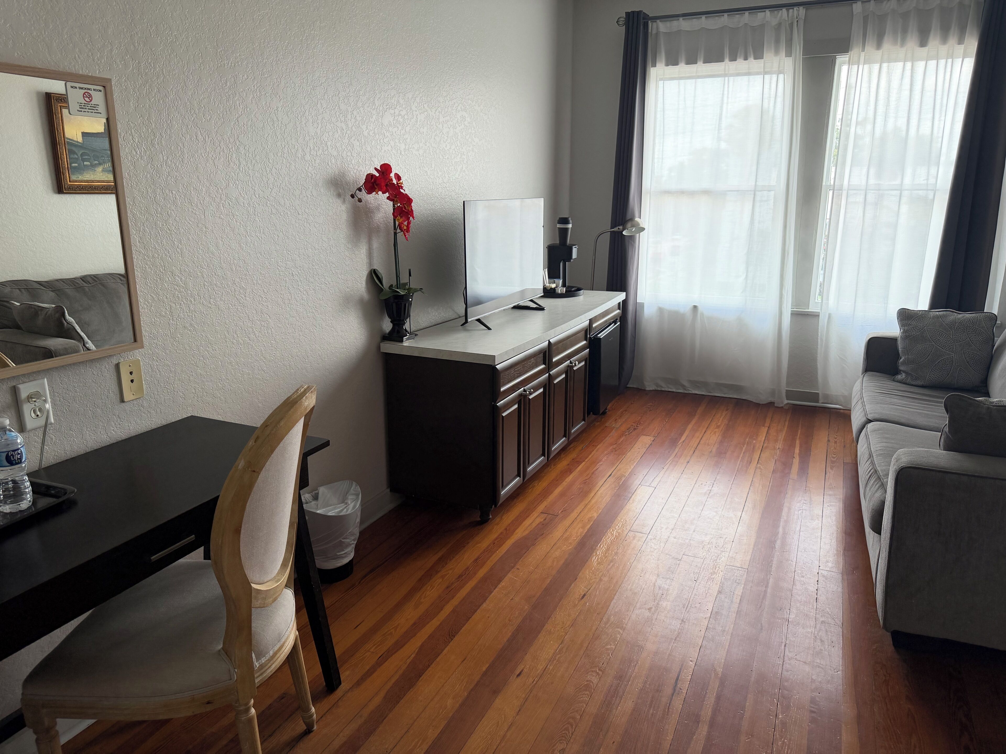A compact living space with a kitchenette, a dining area, and a seating area.