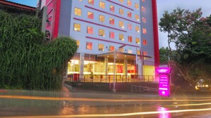 A multi-story hotel with a prominent sign, a well-lit entrance, and a visible staircase leading to the lobby. - favehotel Padjajaran Bogor (Bogor)