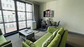 Family Apartment, 2 Bedrooms | Living area | 50-inch LED TV with cable channels