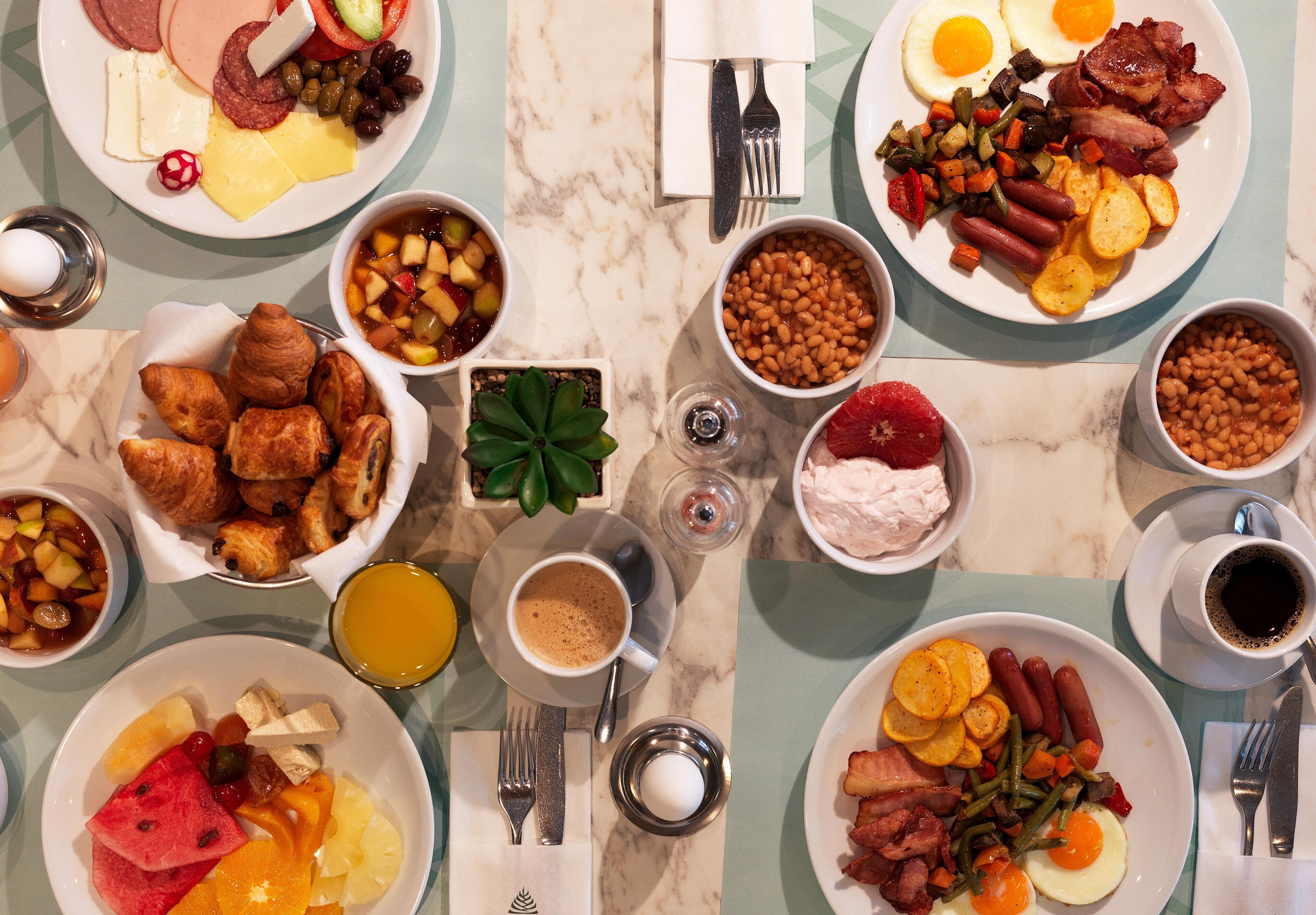 Un bufé de desayuno con diversas opciones de comida y bebidas.
