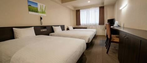 A hotel room with two beds, a desk, a chair, a TV, and a window with curtains.