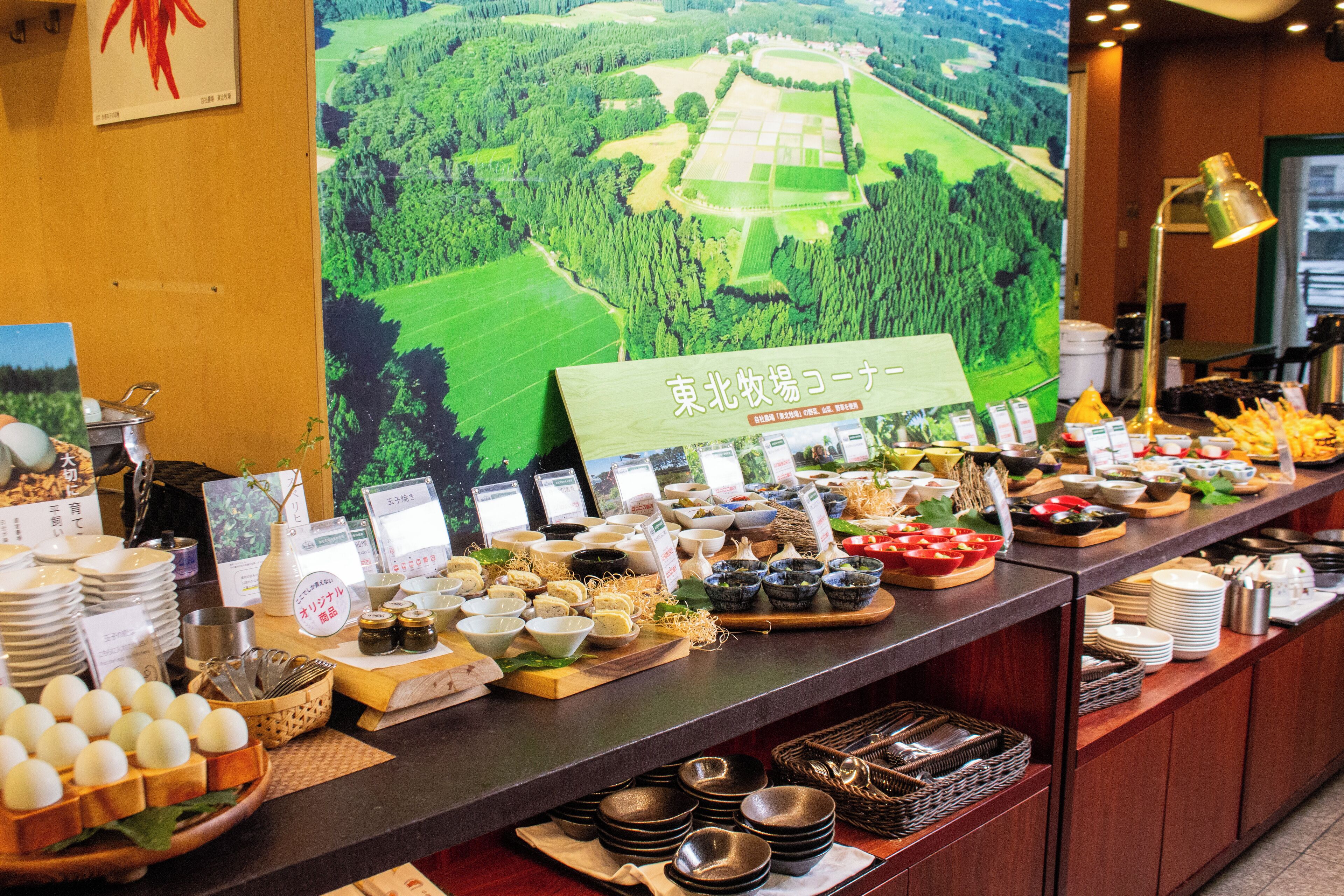 A buffet setup with various food items and a sign indicating a Japanese theme.